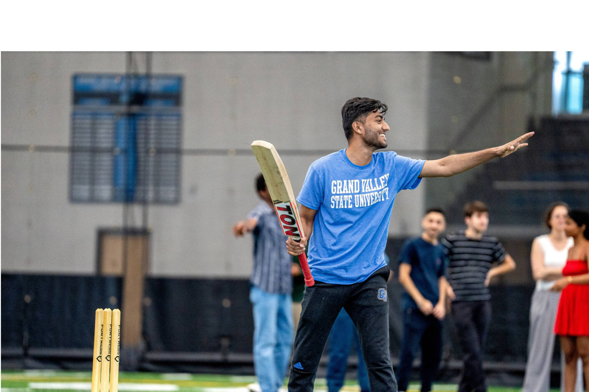 student playing cricket